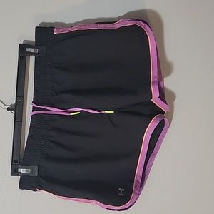 Womens Under Armour black, purple and orange trim running shorts in size medium.
